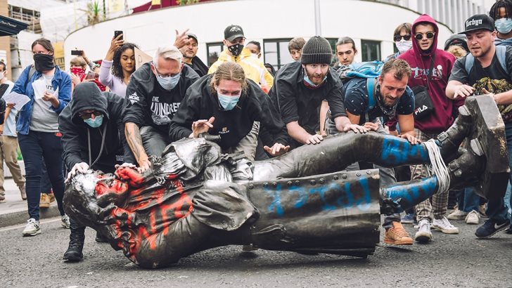 Protesters transport the statue of slave trader Edward Colston towards the river Avon in Bristol, U.K.