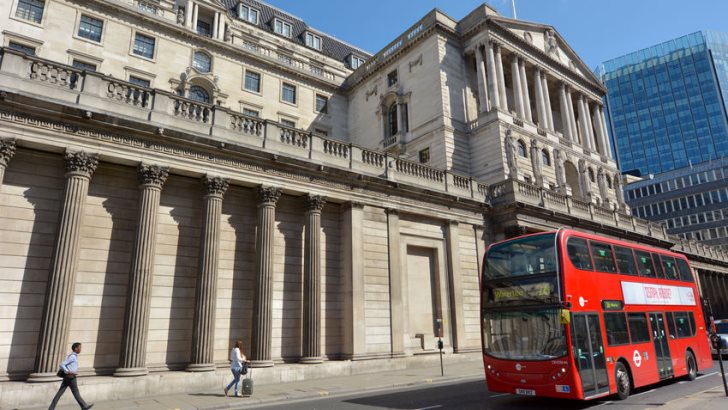 People and traffic pass by the Bank of England's Headquarters in the City of London,