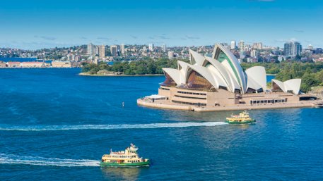 Aerial view of Sydney Harbour with ferries and cruises passing by Sydney Opera House