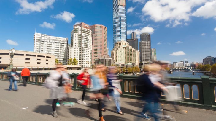 People walking across the Princes Bridge in Melbourne, Australia