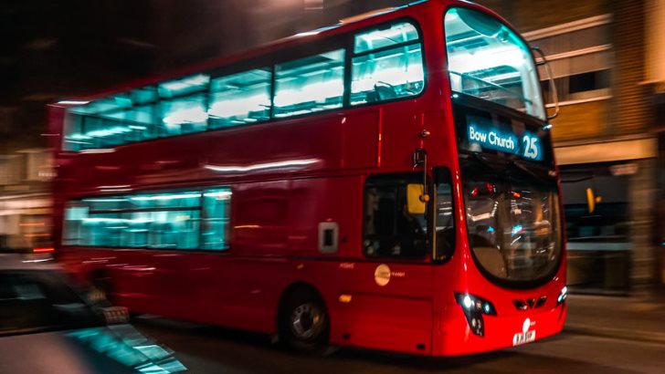 A red London bus in motion