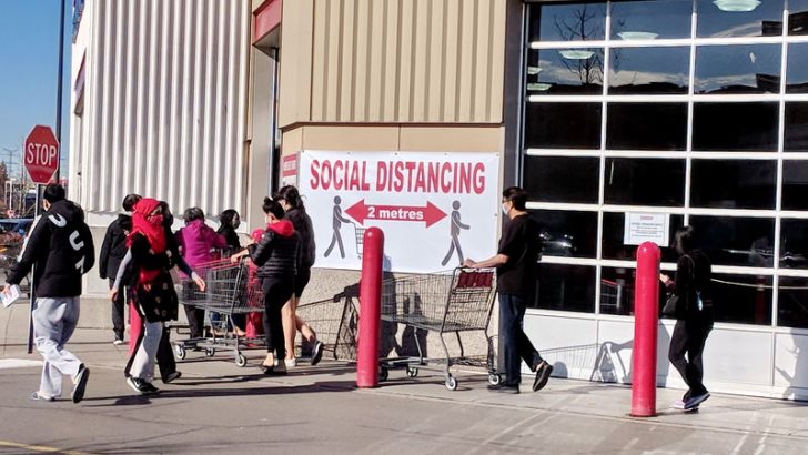 Ontario, Canada, November 11, 2020: People line up at a Costco Store wearing face masks during the Covid-19 virus pandemic