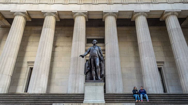 Couple Sitting in Front of the Federal Building in Wall Street