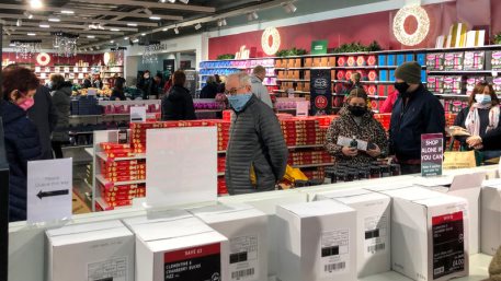 December 2020 shoppers queueing for Marks and Spencer food hall and taking Covid precautions