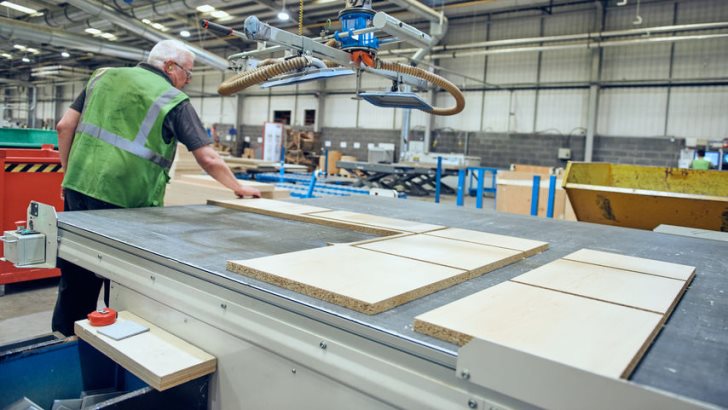 London, England,  Industrial automated robot machinery in an industrial workshop factory environment.