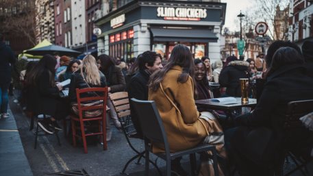 Soho, London | UK - 2021.04.16: People sitting in pubs and restaurants on Friday evening after ending of Coronavirus Lockdown