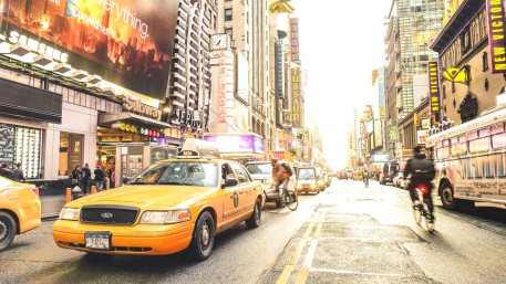 New York yellow taxi cab and everyday life near Times Square in Manhattan downtown before sunset - Intersection of 7th Avenue with 42nd Street