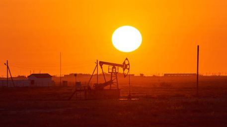 Pumpjack on sunset background. A pumpjack is the overground drive for a reciprocating piston pump in an oil well